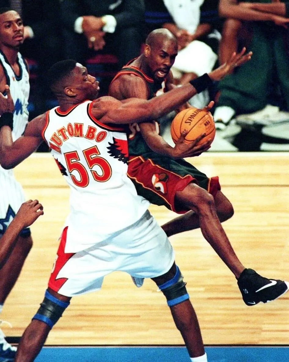 Gary Payton playing lockdown defense during a 1990s NBA game with the Seattle SuperSonics