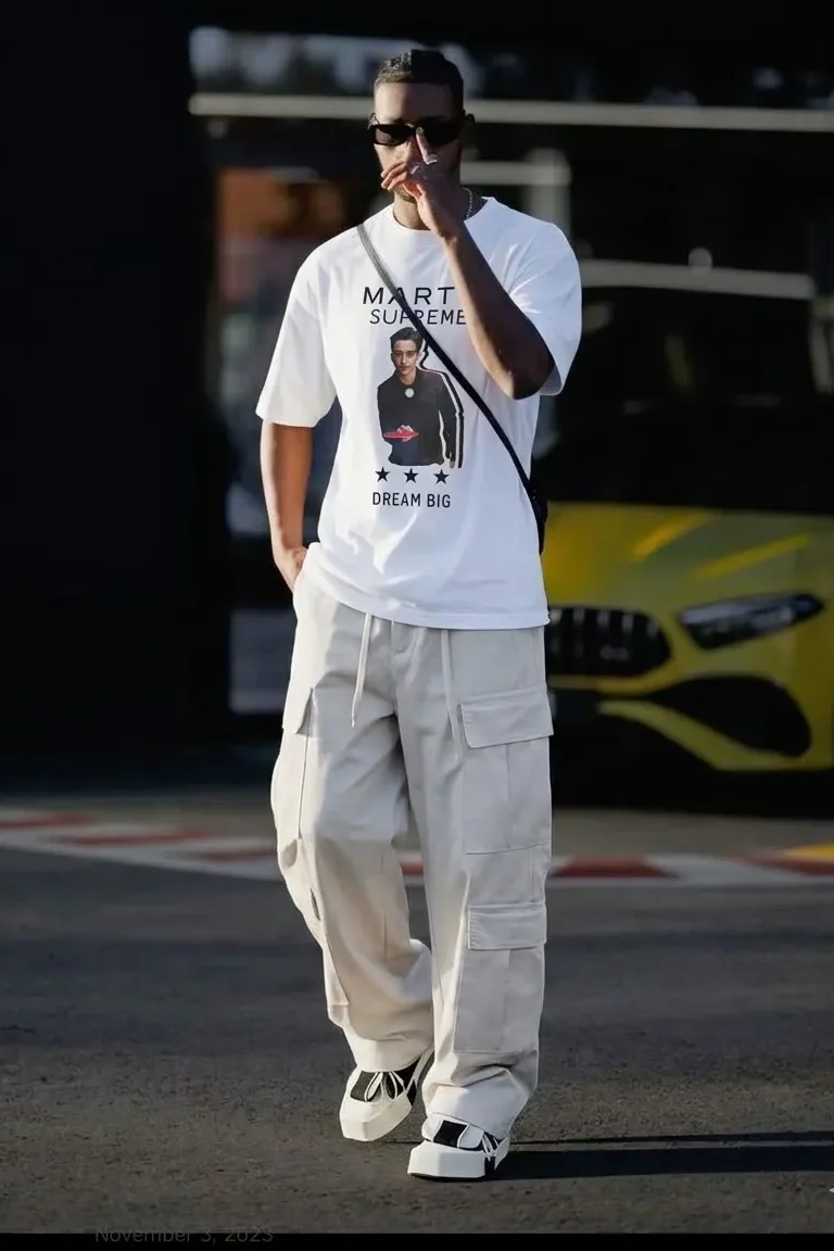 Supreme graphic tee paired with cargo pants in a modern streetwear outfit