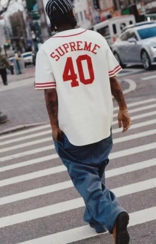 Men’s streetwear look styled with a Supreme graphic tee