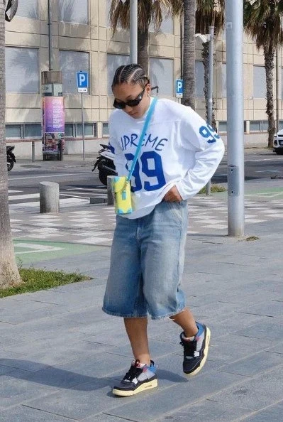 Modern streetwear look featuring a Supreme jersey and baggy jeans