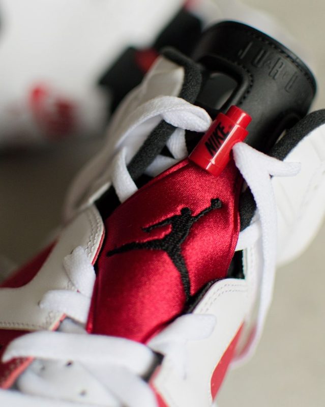 aj 6 carmine tongue close up red satin with lace lock detail