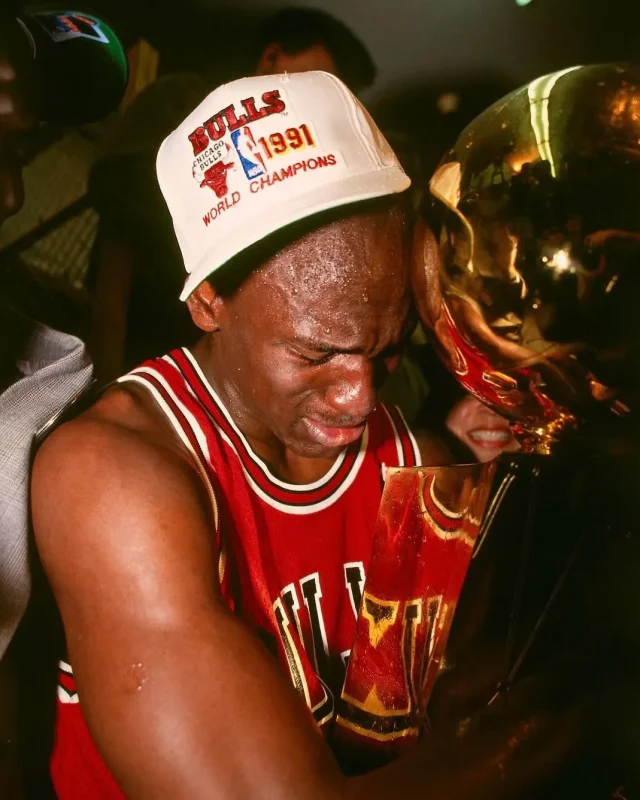 MJ holding championship trophy after winning first NBA title in 1991